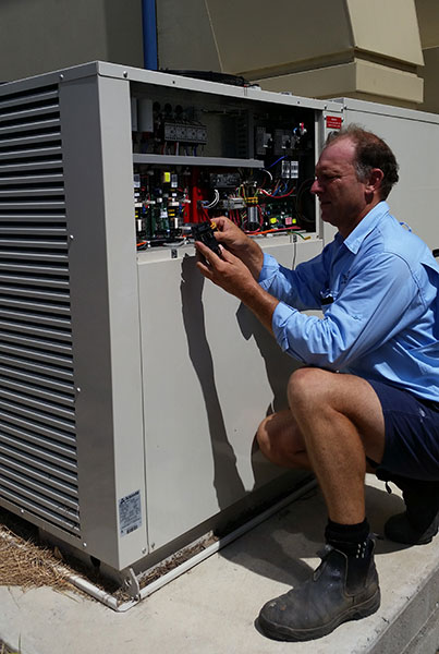 Bob Pizzey servicing commercial air conditioning equipment